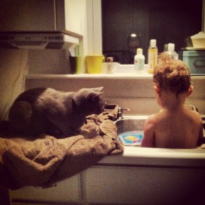Aside from playing and singing, bath time sometimes involves a special (feline) guest.