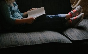 kid reading on couch